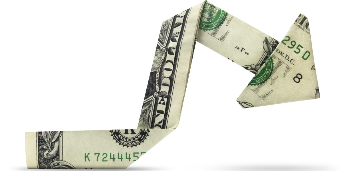 A dollar bill folded into an arrow pointing downward, signifying a reduction in advertising costs in 2021 | THAT Agency of West Palm Beach, FL
