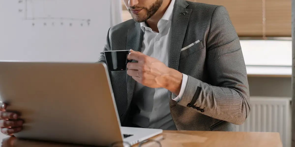 Marketing professional reviewing SEO keyword research on a laptop while planning a digital strategy