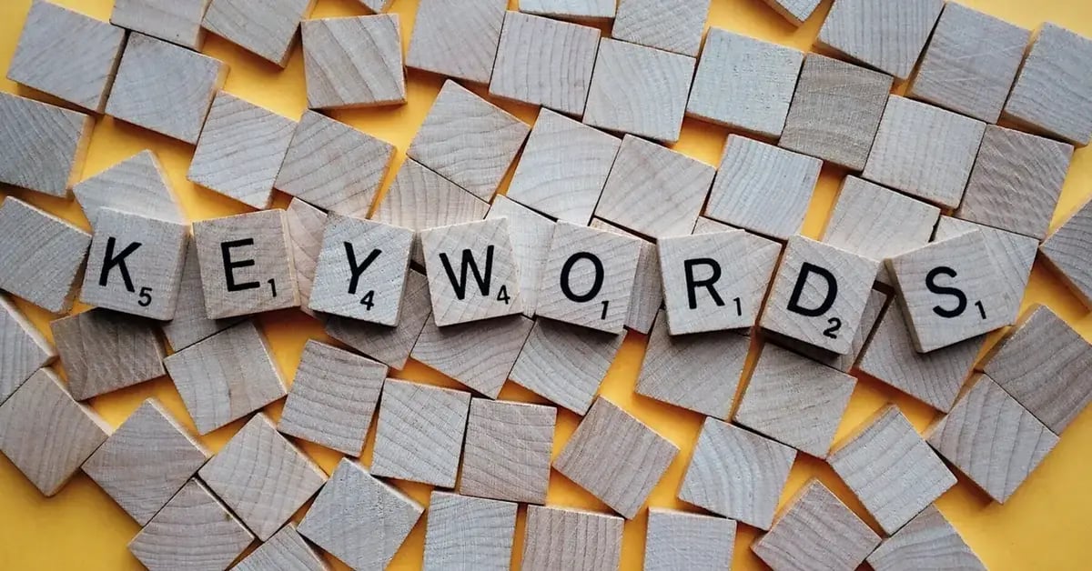 Wooden letter blocks spelling keywords, representing SEO keyword research and content planning