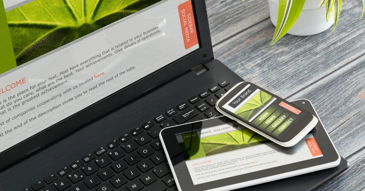 Laptop, tablet, and smartphone displaying a responsive website and social media layout on multiple devices