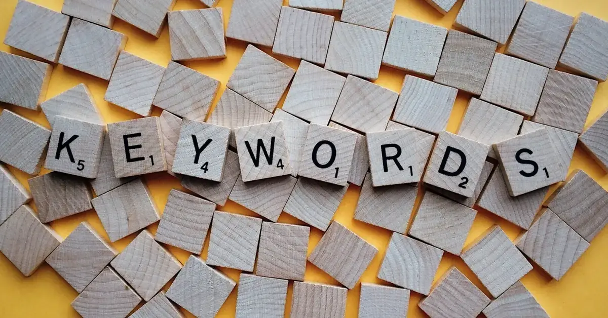 Wooden letter blocks spelling keywords, representing SEO keyword research and content planning